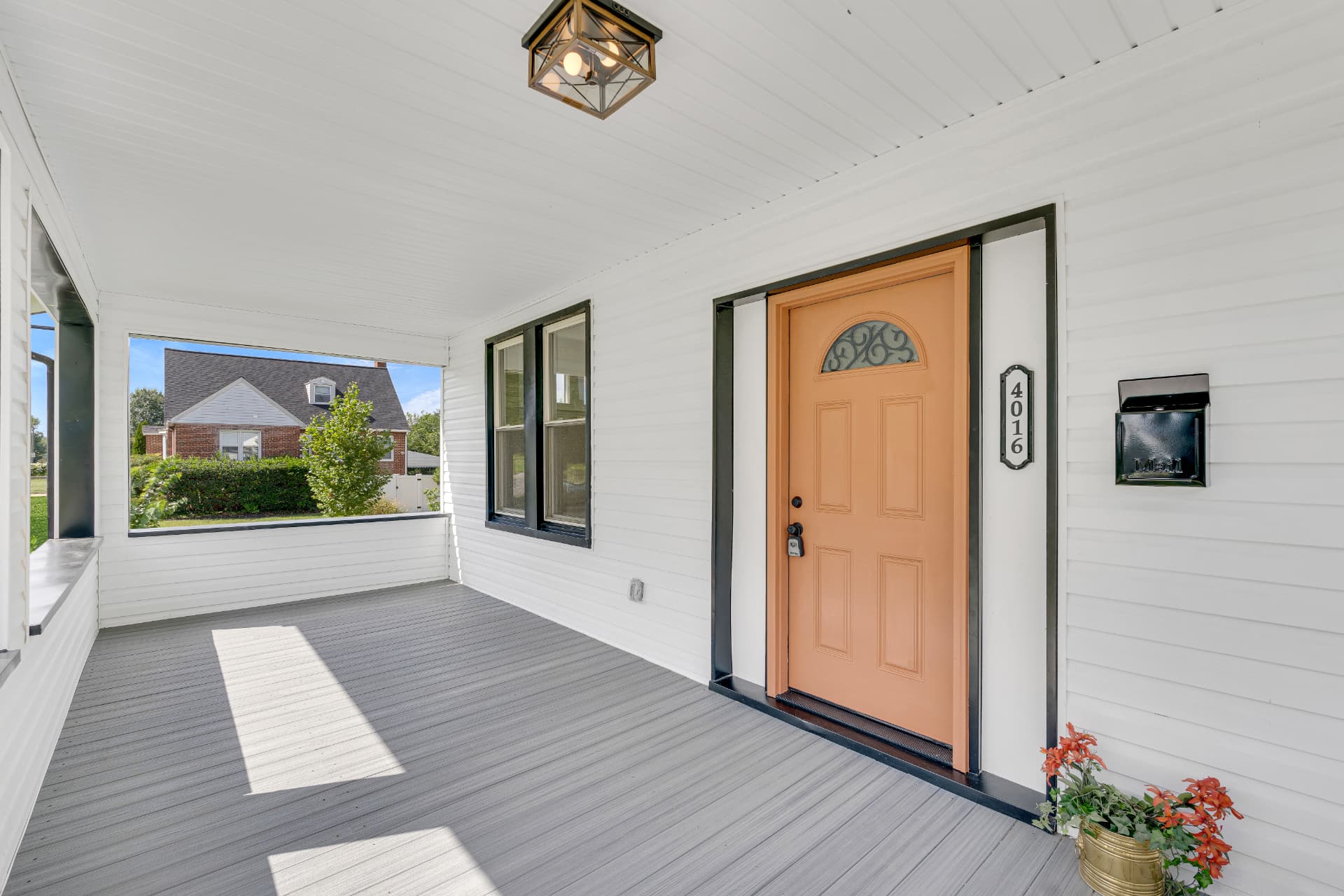 4016 Baltimore home — covered front porch with composite decking and orange entry door