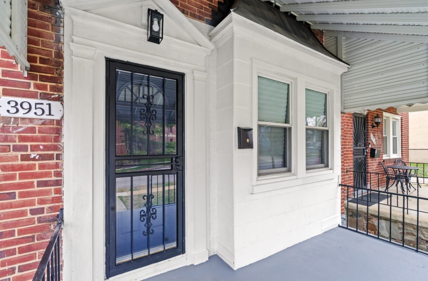 Covered front porch entry of a renovated Baltimore rowhome