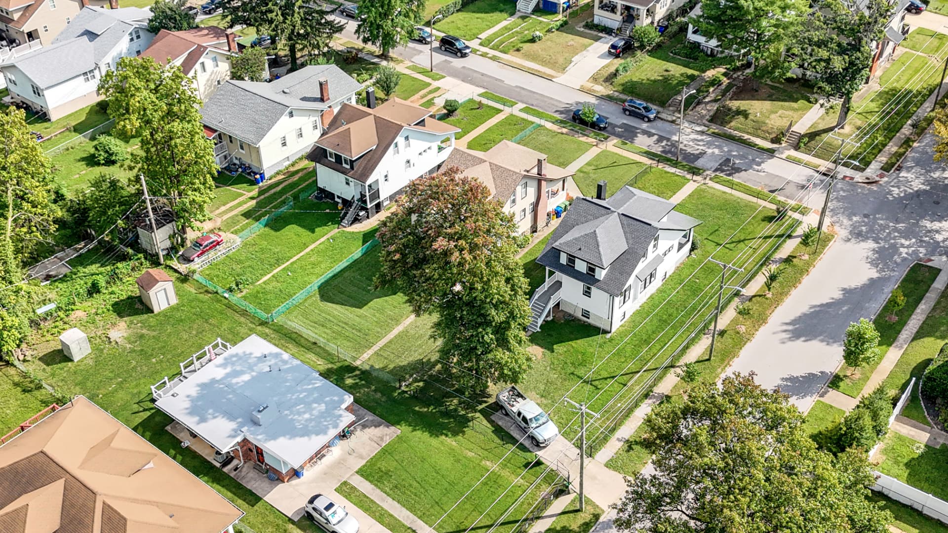 4016 Baltimore home — elevated drone view of the surrounding neighborhood and tree-lined streets