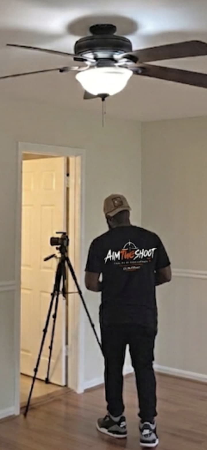 Aimtwoshoot photographer setting up a tripod on location