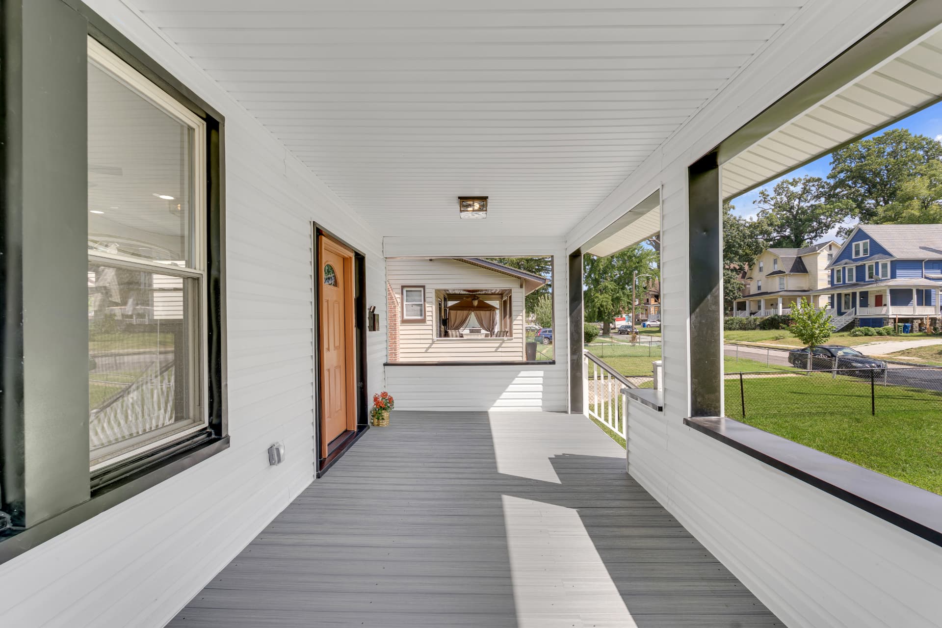 4016 Baltimore home — wraparound porch view overlooking the quiet neighborhood street